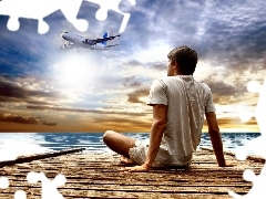 an, pier, sea, a man, plane