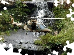 Helicopter, waterfall, rocks