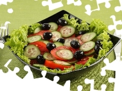 lettuce, cutlery, tomatoes, olives, cucumbers