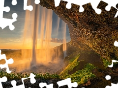 Seljalandsfoss Waterfall, rays of the Sun, rocks, illuminated, iceland