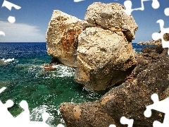 Sky, boulders, sea