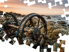 Stones, wheel, sun, sea, west